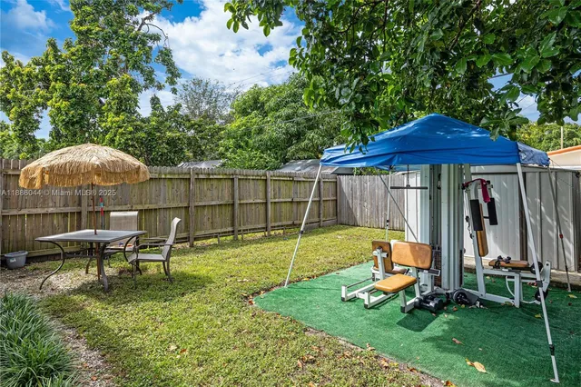 a backyard of a house with table and chairs