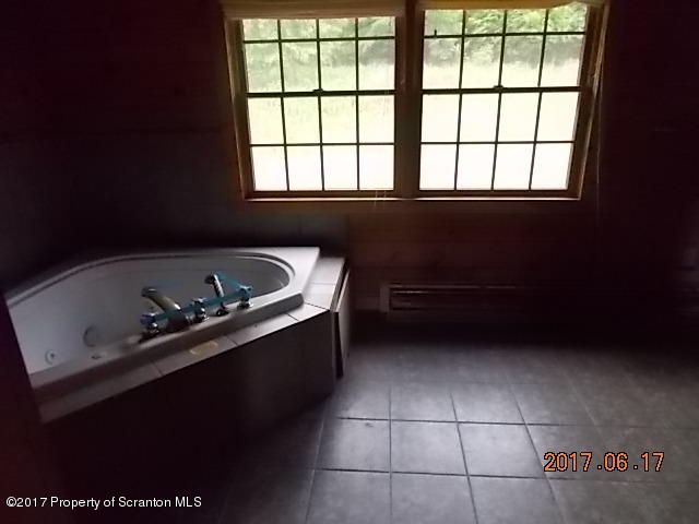 79 Rr 1 Le Raysville, PA 18829 - Photo 13 of 23 a bathroom with a bathtub and window