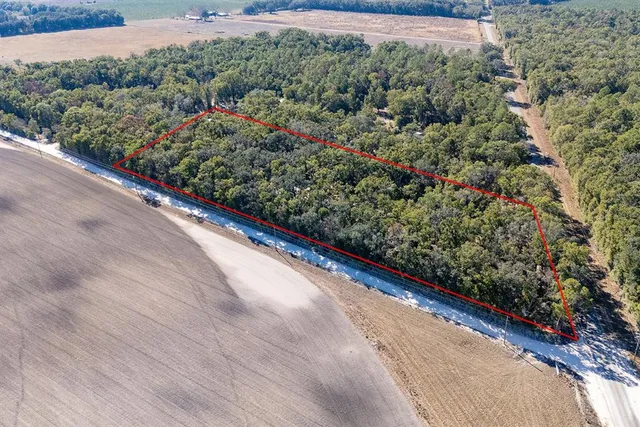 a view of a room with wooden floor staircase and a kitchen