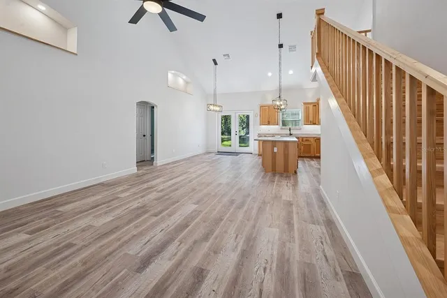 a kitchen with stainless steel appliances granite countertop a stove a refrigerator a sink dishwasher and a oven with wooden floor