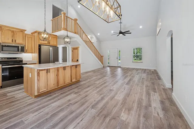 a kitchen with stainless steel appliances a stove microwave and refrigerator