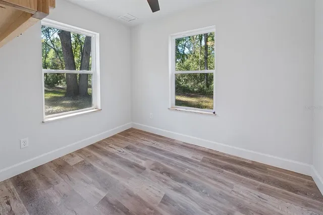 wooden floor in an empty room with a window