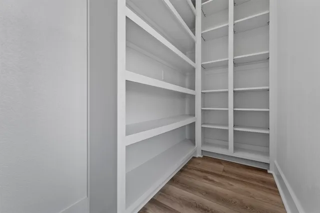 a bathroom with a granite countertop sink a mirror and shower
