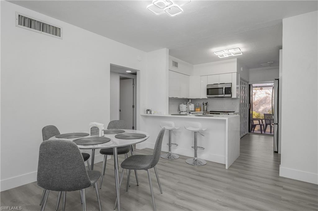 201 South Collier Boulevard, Unit 3102 Marco Island, FL 34145 - Photo 11 of 35 a view of a dining room with furniture and wooden floor