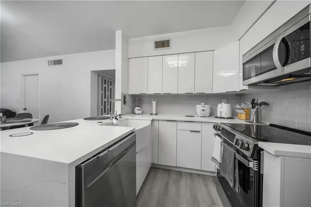 a kitchen that has a sink and a stove in it