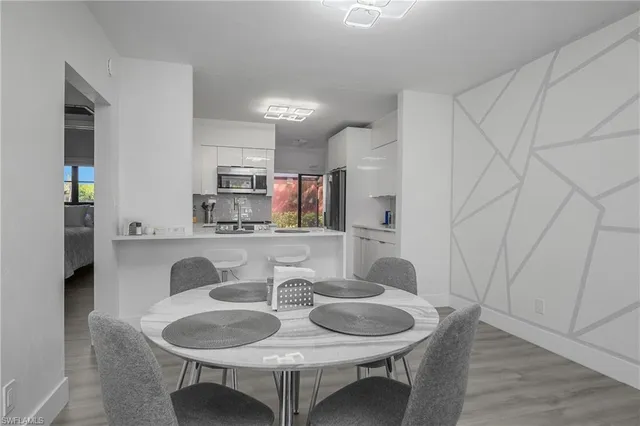 a dining room with furniture and wooden floor