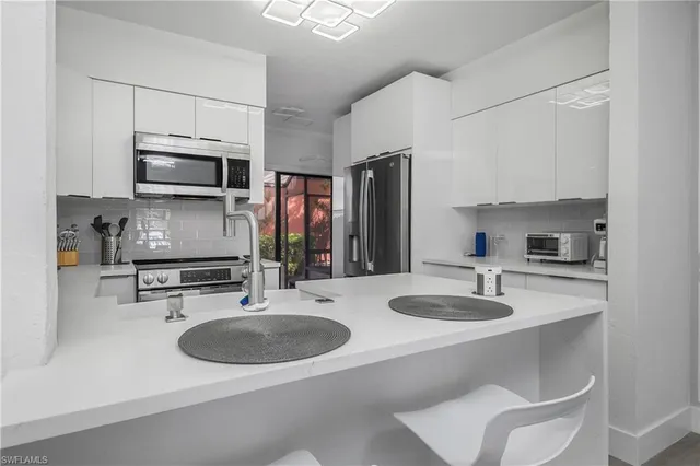 a kitchen with a sink stove and microwave