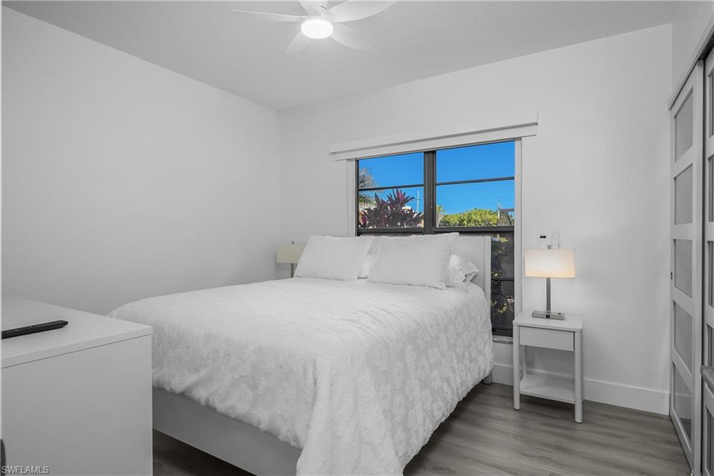 201 South Collier Boulevard, Unit 3102 Marco Island, FL 34145 - Photo 22 of 35 a bedroom with a bed and a table