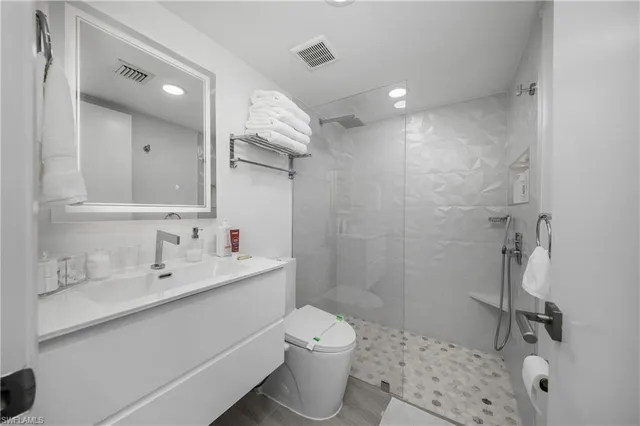 a bathroom with a glass shower door