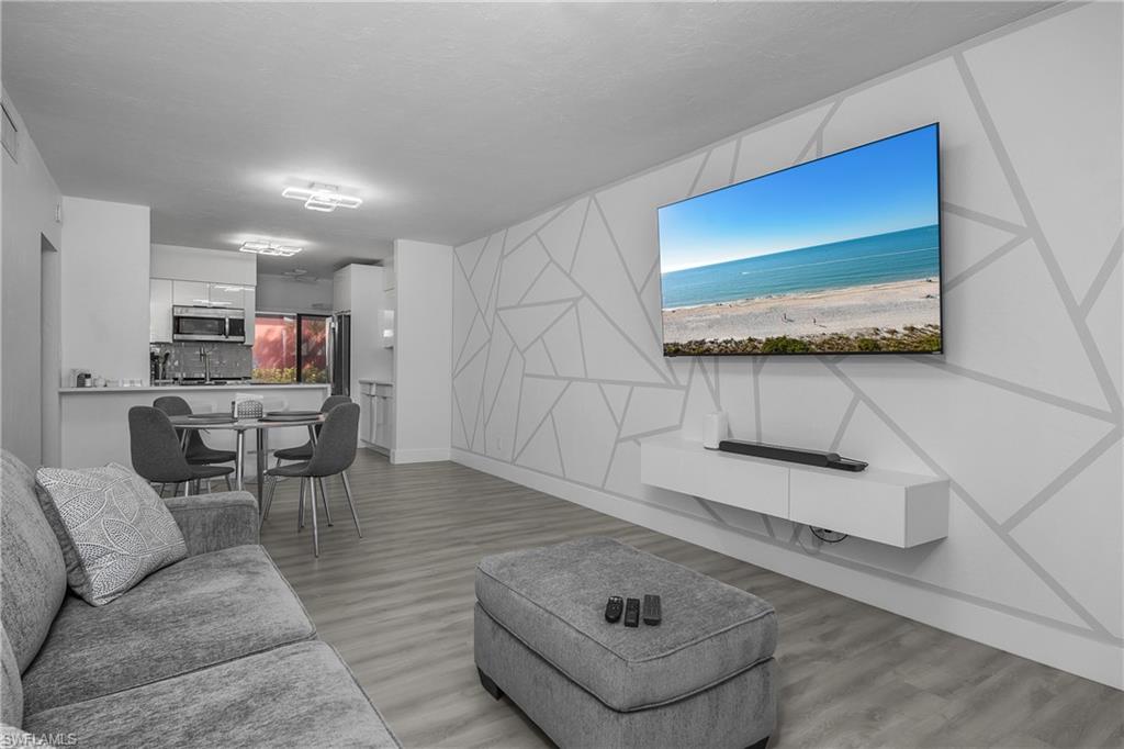 201 South Collier Boulevard, Unit 3102 Marco Island, FL 34145 - Photo 8 of 35 a living room with furniture and a flat screen tv
