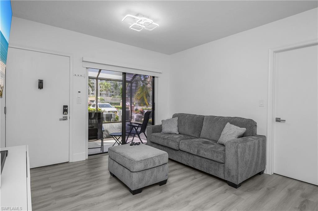 201 South Collier Boulevard, Unit 3102 Marco Island, FL 34145 - Photo 9 of 35 a living room with furniture and a large window