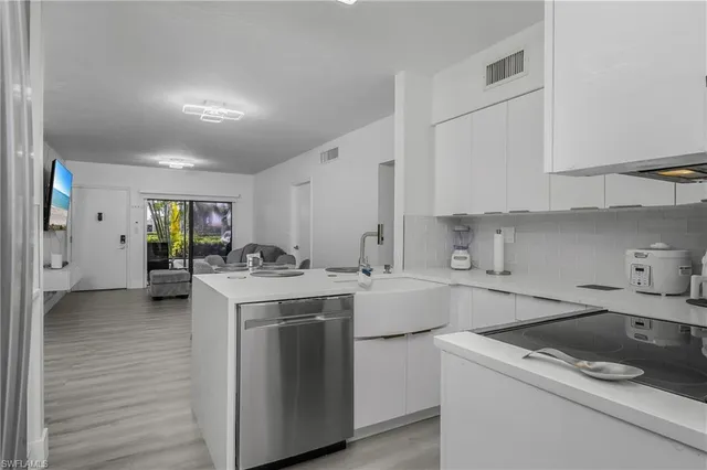 a kitchen that has a sink and a stove in it
