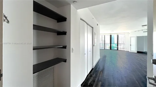 a view of hallway with stairs and wooden floor
