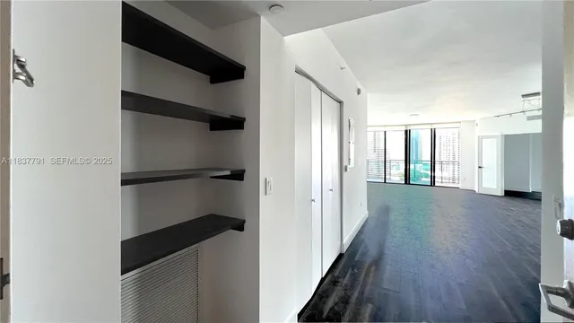 a view of hallway with stairs and wooden floor