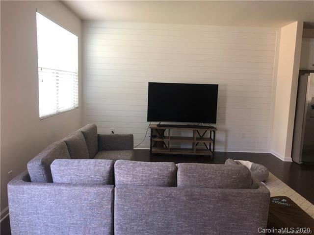 521 Common Raven Court Fort Mill, SC 29715 - Photo 11 of 25 a living room with furniture and a flat screen tv