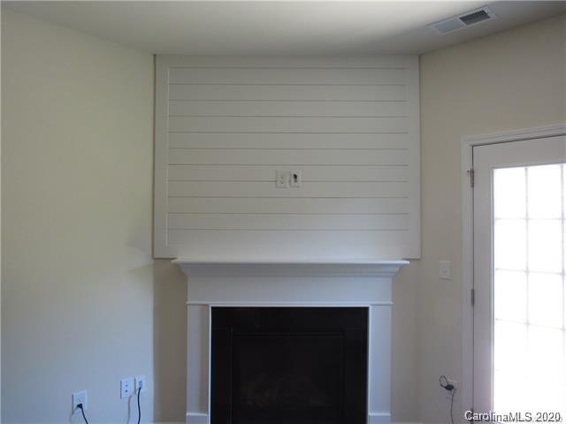521 Common Raven Court Fort Mill, SC 29715 - Photo 12 of 25 a living room with a fireplace