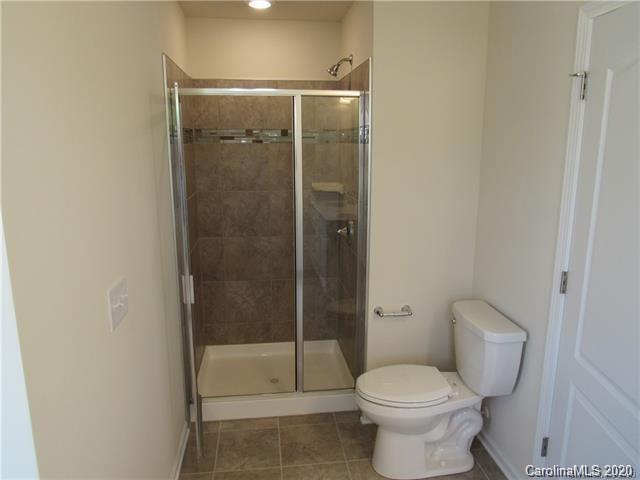 521 Common Raven Court Fort Mill, SC 29715 - Photo 13 of 25 a bathroom with a toilet and a shower