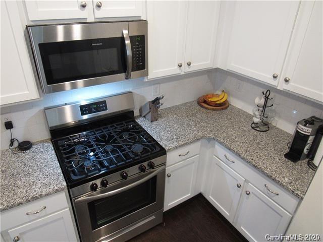 521 Common Raven Court Fort Mill, SC 29715 - Photo 9 of 25 a kitchen with granite countertop stainless steel appliances and cabinets