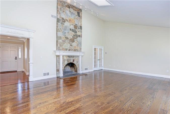 136 Minivale Road Stamford, CT 06907 - Photo 1 of 1 a view of empty room with wooden floor and fireplace