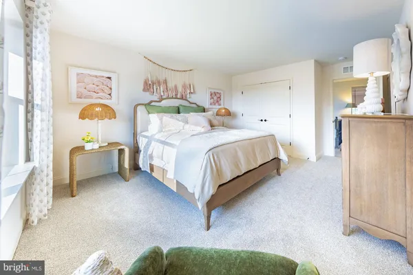 a bed room with a bed mirror and a window