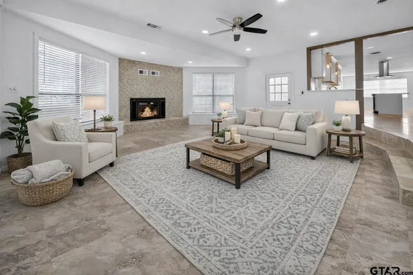 a living room with furniture and a fireplace