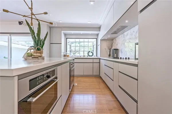 a kitchen with stainless steel appliances a sink stove and cabinets