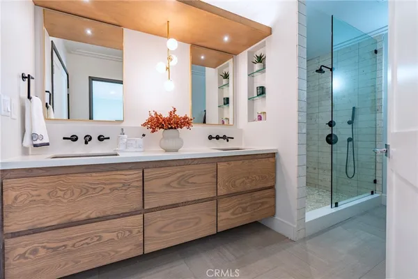 a bathroom with a double vanity sink mirror and double