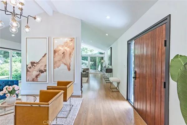 a hallway with wooden floor and furniture