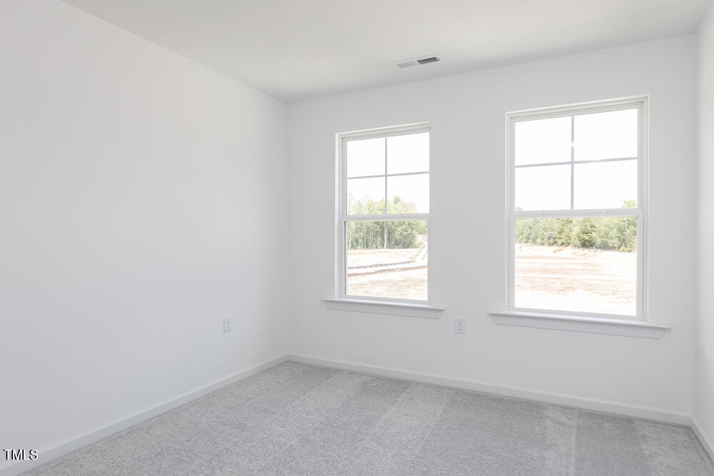 161 Charlie Smith Road Angier, NC 27501 - Photo 21 of 57 an empty room with a window