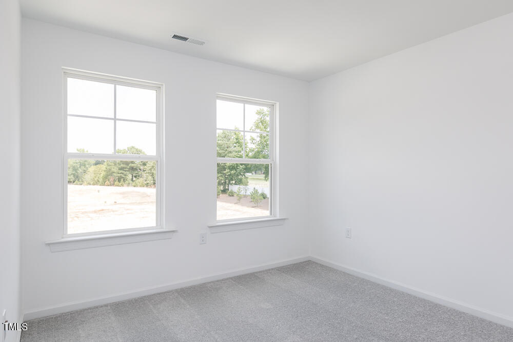161 Charlie Smith Road Angier, NC 27501 - Photo 23 of 57 an empty room with windows