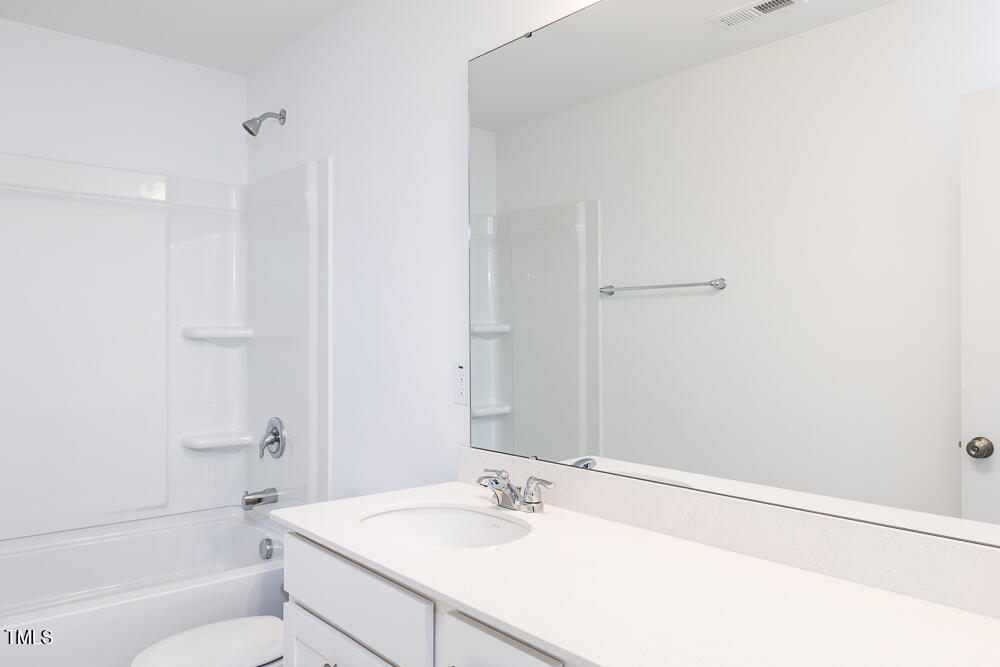161 Charlie Smith Road Angier, NC 27501 - Photo 25 of 57 a bathroom with a sink a toilet and shower