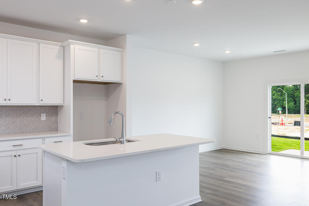 161 Charlie Smith Road Angier, NC 27501 - Photo 7 of 57 a kitchen with kitchen island a sink and a stove top oven