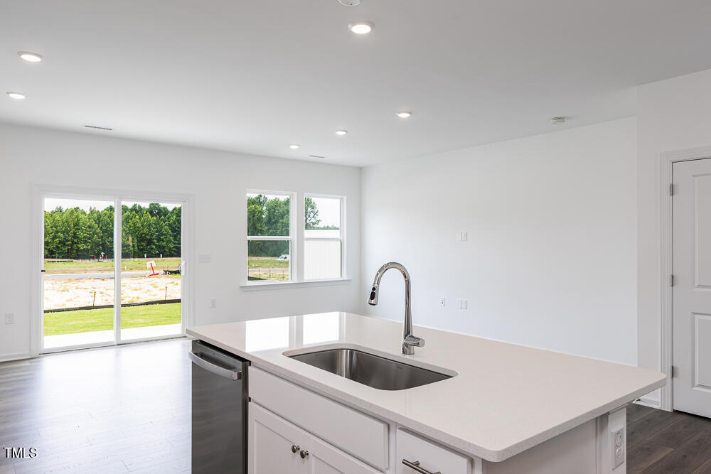 161 Charlie Smith Road Angier, NC 27501 - Photo 8 of 57 a kitchen with a sink and a refrigerator