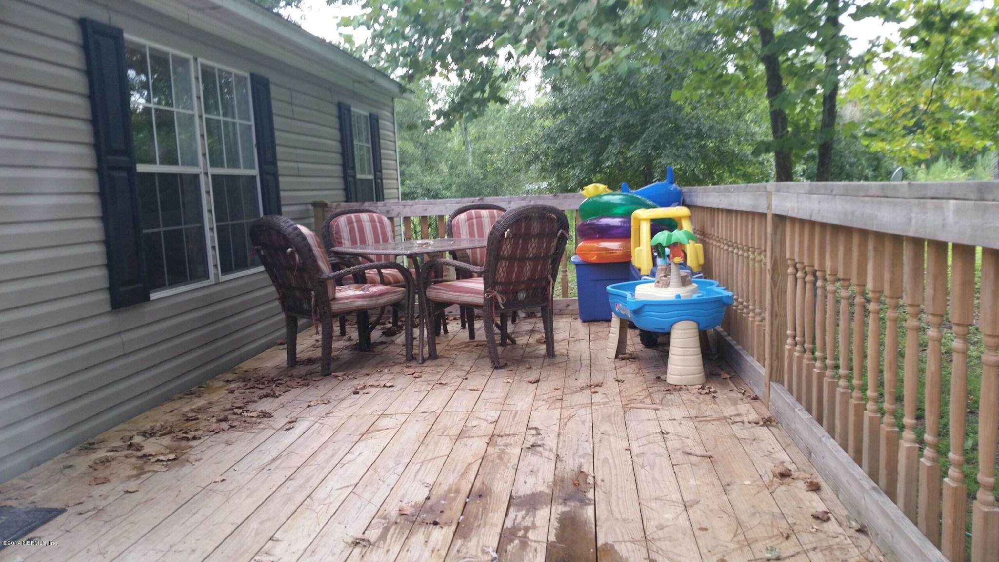 1765 Bennett Road St. Augustine, FL 32092 - Photo 3 of 21 a view of deck with table and chairs wooden floor and fence