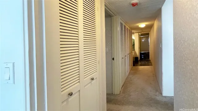 a view of a hallway with a wooden door