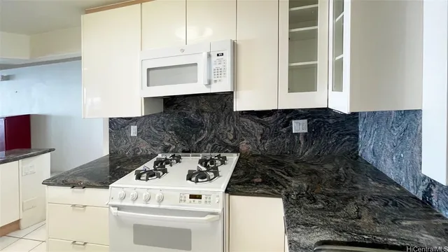 a kitchen with a stove and a cabinets