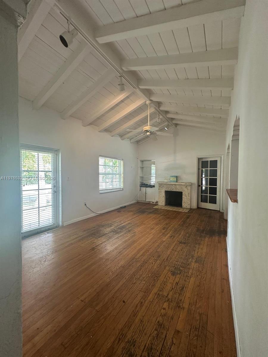 901 Northwest 10th Court Miami, FL 33136 - Photo 11 of 13 a view of empty room with a fireplace and windows