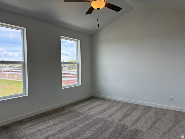 1883 West 1575th North, Unit 236 Layton, UT 84041 - Photo 16 of 22 Spare room featuring a ceiling fan, dark carpet, and lofted ceiling
