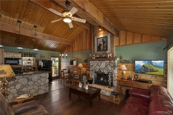a living room with furniture a fireplace and next to a window