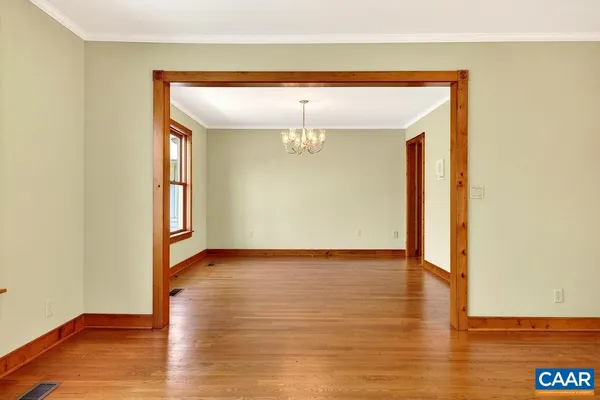 a kitchen with stainless steel appliances granite countertop a sink a stove cabinets and a dining table