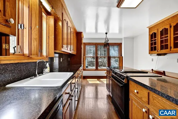 wooden floor fireplace and windows in an empty room