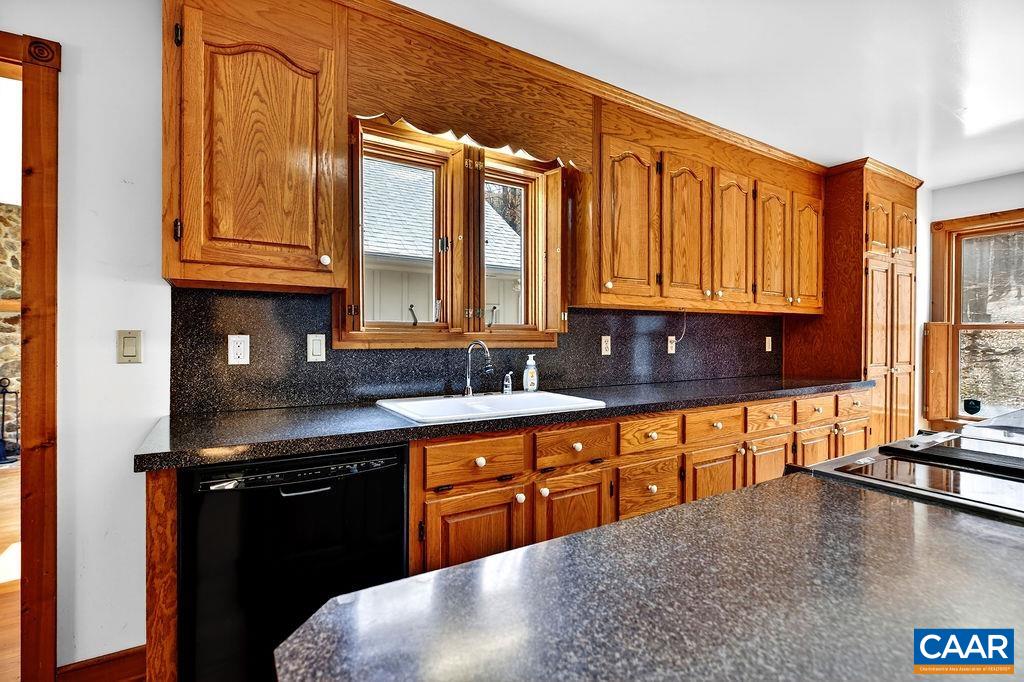 472 Horseshoe Mountain Road Roseland, VA 22967 - Photo 19 of 75 a kitchen with stainless steel appliances granite countertop a sink a stove cabinets and a dining table