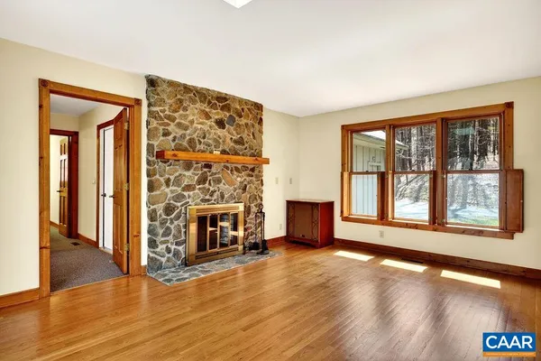 a view of house with wooden stairs and a large window