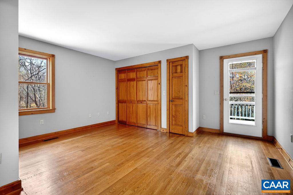 472 Horseshoe Mountain Road Roseland, VA 22967 - Photo 30 of 75 a view of an empty room with glass door and wooden floor