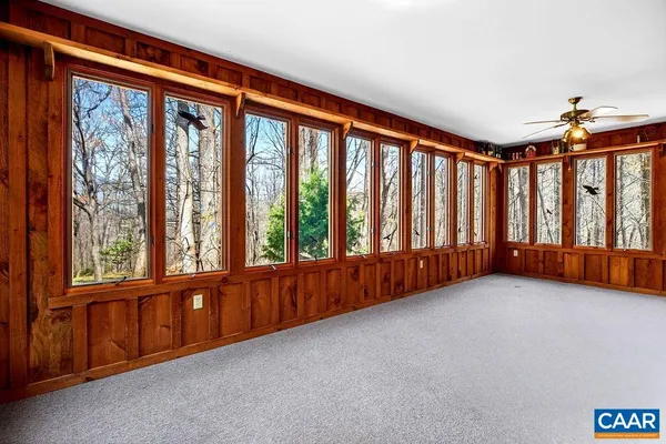 a view of an empty room with wooden floor and closet