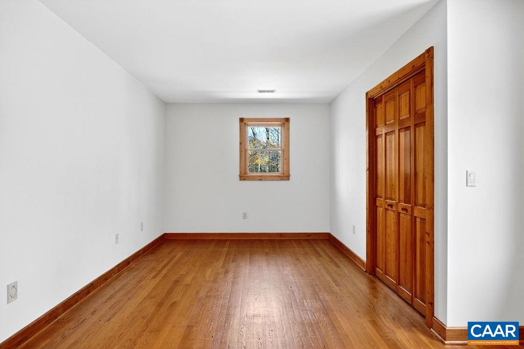 472 Horseshoe Mountain Road Roseland, VA 22967 - Photo 48 of 75 an empty room with wooden floor and windows