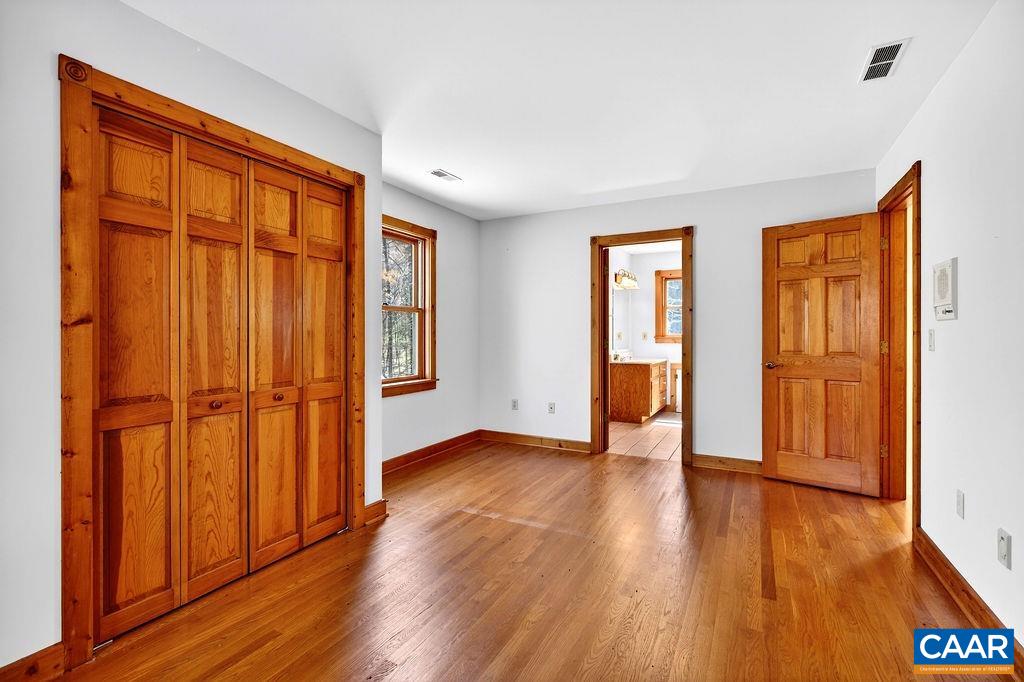 472 Horseshoe Mountain Road Roseland, VA 22967 - Photo 49 of 75 an empty room with wooden floor and a window
