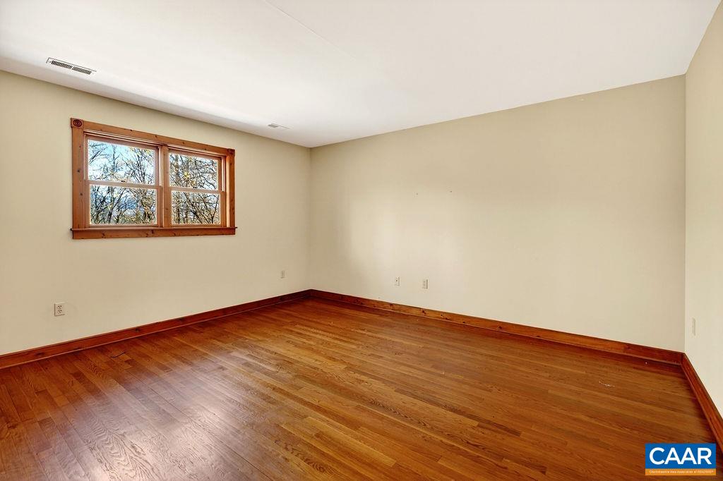 472 Horseshoe Mountain Road Roseland, VA 22967 - Photo 52 of 75 a view of an empty room with wooden floor and a window