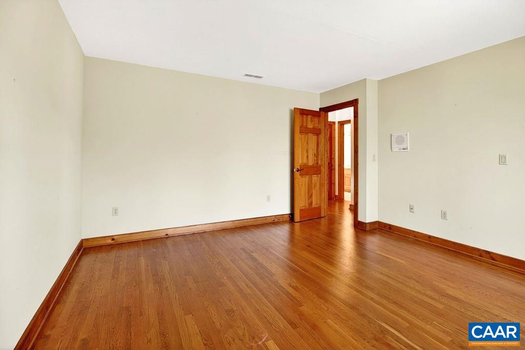 472 Horseshoe Mountain Road Roseland, VA 22967 - Photo 54 of 75 a view of an empty room with wooden floor and closet