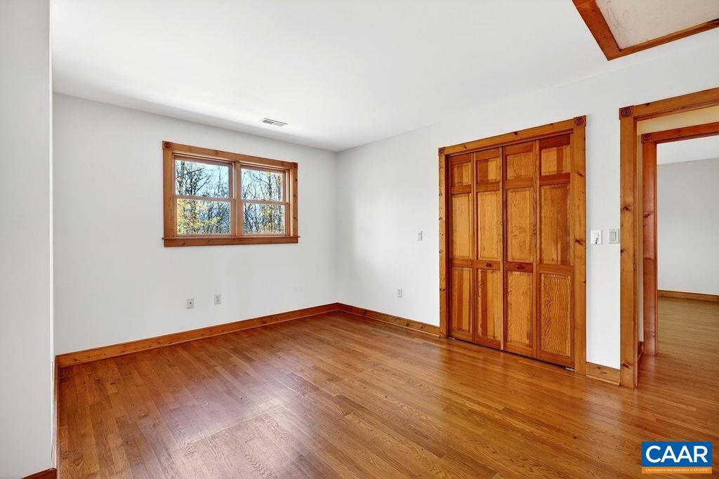 472 Horseshoe Mountain Road Roseland, VA 22967 - Photo 56 of 75 an empty room with wooden floor and windows